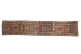 Distressed Karaja rug runner with a column of hooked medallions in rust, powder blue, and ivory.