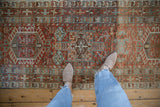 Detailed view of the geometric medallions and abrashed colors on a vintage distressed Karaja runner.