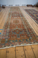 Angled view down the length of a distressed Karaja runner showing its repeating geometric medallions.
