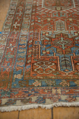 Softly worn pile of a vintage Karaja rug with rust and dusty blue geometric motifs.
