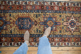 Sapphire blue hook and latch medallions on the ochre field of a vintage Persian Karaja runner.