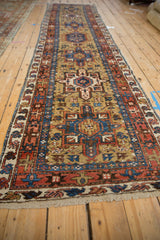 Vintage Karaja rug runner viewed from a low angle, emphasizing its length and geometric design.