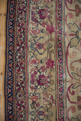Antique Kermanshah runner's minor floral border with cochineal red, navy, and aged pile.