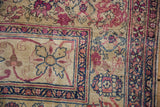 Antique Kermanshah runner's reconditioned border with cochineal red and navy floral vinery.