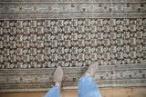 Distressed Kurdish Hamadan runner with faded chocolate brown, beige, and dusty blue reciprocating plant motifs.