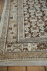 Distressed Hamadan runner corner, chocolate brown plant motifs and floral border.