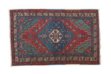 Northwest Persian vintage rug with a blue hexagonal medallion, red field, and green corner spandrels.