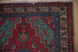 Detail of a Persian rug's polychromatic selvage, corner spandrel, and hand-knotted fringe.