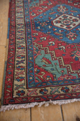 Detail of the corner spandrel in sapphire blue and cherry red on a vintage Persian rug.