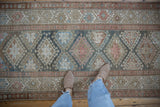Distressed Hamadan runner featuring geometric diamond guls in slate blue, blush, and coffee brown tones.