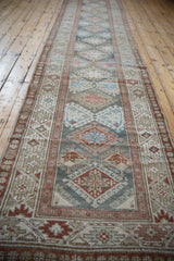 Distressed Persian Hamadan runner featuring geometric diamond guls and muted blue, blush, and coffee tones.
