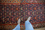 Hand-knotted Hamadan runner detail, Herati leaves, blossoms, cobalt blue, cherry red, visible wear.