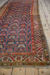 Vintage Hamadan runner's field of Herati stylized leaves and serrated leaf border.