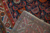 Vintage Hamadan rug runner detail showing Herati-style pile motifs and woven foundation.