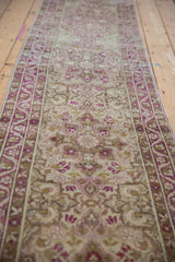 Angled view down the length of a distressed Yezd runner, showing the pattern flow and worn texture.