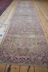 Angled view of the distressed Yezd runner's full length, showing even wear and magenta details.