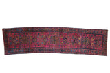 Raspberry red Lilihan runner with stylized palmettes and hidden animal motifs.