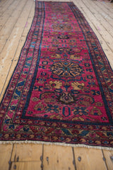 Repeating stylized pomegranate medallions and Herati palmettes on a raspberry red Lilihan runner.
