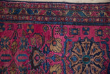 Vintage Lilihan rug detail showcasing raspberry field with sapphire blue and coffee brown patterns.