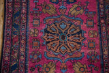 Vintage Lilihan rug: raspberry field with sapphire palmettes and unusual hidden animal motifs.