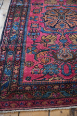 Raspberry red Lilihan runner field with stylized sapphire blue pomegranates and pinwheel flowers.