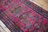 Hand-knotted Lilihan runner with fuchsia and sapphire blue curvilinear floral motifs.