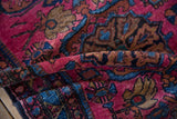 Plush fuchsia pile and sapphire blue palmettes on the vintage Lilihan rug.