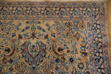 Scrolled leaves and paisley botehs in the blue border of a hand-knotted vintage Meshed runner.