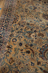 Low pile texture of a vintage Meshed rug showing intricate blossoms and a blue paisley border.