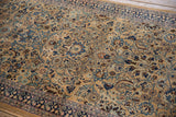 Intricate paisley botehs and scrolled leaves in shades of blue and brown on a camel ground.