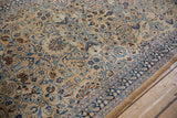 Angled detail of a vintage Persian rug's allover design with paisley botehs and palmettes.
