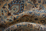 Close-up of a vintage Meshed rug's varied pile height, with slate blue and brown boteh motifs.