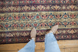 Antique Kermanshah runner section with Shadow Samovar vinery, arabesque borders in ivory, red, and blue.