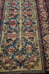 Antique Kermanshah runner detail: dusty teal Samovar patterns on ivory field and intricate dark border.