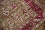 Close-up showing the low, textured pile and knot heads of a distressed Armenian Karabagh rug.