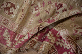 A close-up view of the soft, distressed low pile on a folded vintage Karabagh runner.