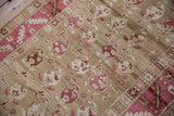 A close view of the low-pile texture, showing alternating botehs in raspberry and ivory.