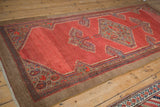 Angled perspective of a vintage Serab runner's geometric medallion on an abrashed red field.