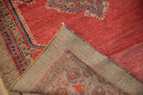 Folded corner of a vintage Persian Serab rug revealing its camel hair foundation.