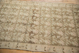 Distressed vintage Karabagh runner with faded blush and ivory vines on coffee brown.