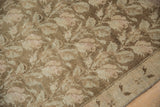 Distressed Karabagh runner detail, showing faded floral vines, coffee brown pile, and foundation.