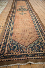Distressed Hamadan runner's faded lattice field and geometric borders with dusty teal and madder red.