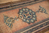 Distressed Hamadan runner's dusty teal floral finial and detailed pawn motif border.