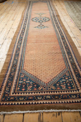 Distressed Hamadan runner corner shows lattice field and dusty teal, madder red pawn border.