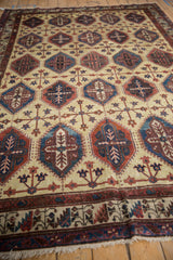 Angled view showing the repeating panel design on a vintage Northwest Persian carpet.