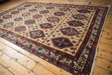 Repeating panel motif with inverted red and blue coloration on a vintage Persian carpet.