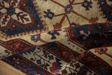 A soft fold in the vintage Persian carpet reveals its low, hand-knotted pile and boteh border.