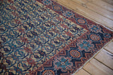 Corner view of an antique Afshar rug showing the geometric border and intact side cord selvage.