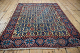Full view of a square antique Afshar rug highlighting its staggered row and lattice design.