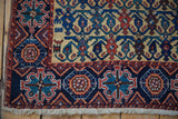 Navy geometric border, intact side cord, and ivory fringe on an antique Afshar rug corner.